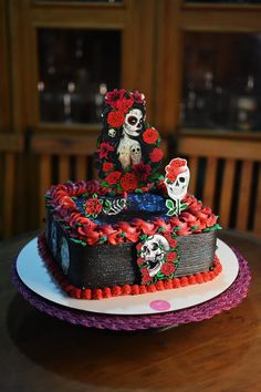 a cake decorated with sugar skulls and roses