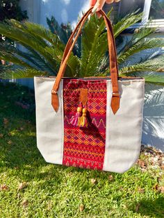 This stunning embroidered tribal tote bag is an absolute must-have. Incredible detailing with breathtaking colors that will have everyone complimenting. Beautifully made by Artisans in Mexico.  Large enough to use for shopping, use as a diaper bag, school, beach, and everyday use.  Please advise that each bag is handmade and each design will vary. Colors may slightly be different due to photo editing and natural light placement. If you want a specific one please message me.  Measurements: 12 inc Bohemian Large Capacity Tote Canvas Bag, Bohemian Large Capacity Canvas Tote Bag, Bohemian Natural Canvas Bag For Everyday Use, Bohemian Natural Canvas Bag For Travel, Folk Style Handwoven Shoulder Bag For Everyday Use, Embroidered Natural Tote Shoulder Bag, Daily Use Tote Shoulder Bag With Weaving Work, Bohemian Beige Canvas Tote Bag, Beige Bohemian Canvas Tote Bag