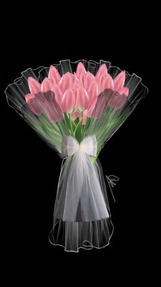 a bouquet of pink tulips in a clear vase with a white bow on the side