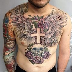 a man with tattoos on his chest has a cross and wings