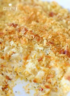 a casserole dish with cheese and other toppings is shown on a white plate