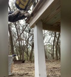 a bucket sitting on top of a wooden porch