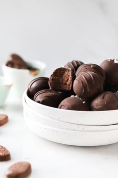 a white bowl filled with chocolate covered cookies