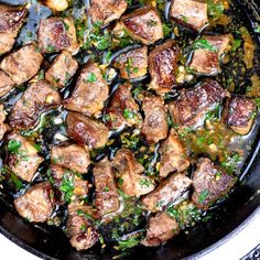 meat and vegetables cooking in a skillet