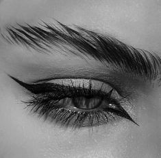 black and white photo of an eye with long lashes