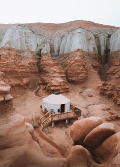 a small house in the middle of some rocks