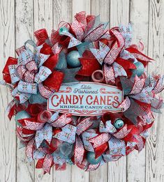 a red, white and blue wreath with candy canes written on the front door