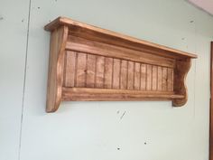 a wooden shelf mounted to the side of a wall