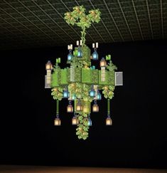 a green chandelier hanging from the ceiling in a room with black walls and flooring