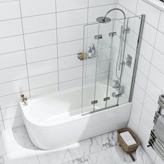 a bathroom with white tile walls and flooring has a glass shower door that opens up to the bathtub