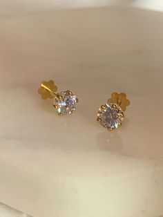 A stunning pair of  - 18 carat gold studs - 5.5mm - Cubic zirconia stone - Flat screw back - Bar length: 6-7mm - Makers mark on screw - total weight: 0.55 grams approximately  Ideal for adutls and children. designed for comfort wear.  Please ensure you are certain about these studs as all jewellery items are no exchange/no refund.  All items are carefully checked, packed and posted by me for next day delivery.  Please note, the price is reflective of a pair/2 pieces. Classic Gold Plated Round Diamond Earrings, Classic Gold Diamond Earrings, Tarnish Resistant, Classic Cubic Zirconia Diamond Earrings, Classic Gold Diamond Earrings With Brilliant Cut, Gold Screw Back Round Cut Jewelry, Gold Solitaire Diamond Earrings For Anniversary, Gold Solitaire Round Earrings, Gold Solitaire Diamond Earrings Gift, Gold Solitaire Earrings As A Gift