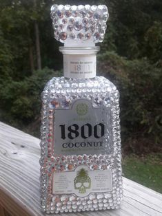 an old fashioned bottle is decorated with jewels