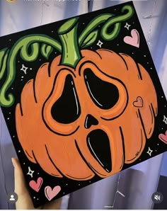 someone holding up a halloween card with an image of a pumpkin on it