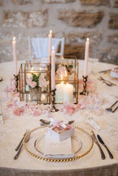 the table is set with candles and place settings