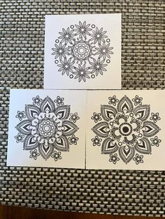 three cards with black and white designs on them