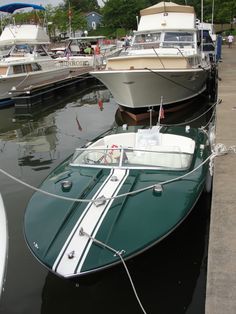 two boats are docked in the water next to each other