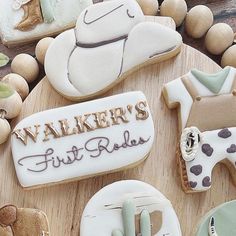 decorated cookies are arranged on a wooden platter with the words walker's first ride