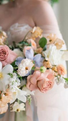 a bride holding a bouquet of flowers in her hands