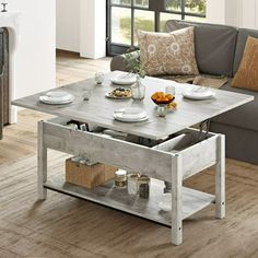 a living room with a couch, coffee table and other items on the wooden floor