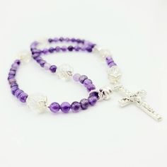 This handmade magnetic closure rosary bracelet is made with 4mm natural amethyst beads, 6x8mm rondelle crystals, and Tibetan silver bead caps featuring a 1 inch silver-tone cross and 10mm Miraculous Medal bead. All other findings are silver plated. All rosary parts are made in Italy. This bracelet is ~8 inches long. Each bracelet in my shop is handmade by yours truly. And I back all of my work with a 100% satisfaction guarantee. If you are not completely satisfied, please contact me directly and Sterling Silver Spiritual Rosary Bracelet With Cross, Sterling Silver Cross Rosary Bracelet, Spiritual Sterling Silver Cross Rosary Bracelet, Adjustable Spiritual Rosary Bracelet With Silver Beads, Adjustable Silver Beads Spiritual Rosary Bracelet, Adjustable Silver Rosary For Meditation, Silver Spiritual Rosary Bracelet With Gemstone Beads, Adjustable Spiritual Rosary With Spacer Beads, Silver Rosary Bracelet With Round Beads For Meditation