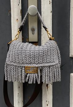 Iconic medium Baguette bag made of soft, green wool and decorated with an FF clasp. Featuring a front flap with long fringes, magnetic clasp, internal compartment lined in FF fabric and with a zipper pocket, and gold-finish metalware.The bag can be carried by hand, or worn either on the shoulder or cross-body thanks to the tone on tone leather shoulder strap and handle, both detachable.Made in Italy Luxury Fringe Rectangular Bag, Luxury Top Handle Shoulder Bag With Fringe, Designer Bags With Tassels, Luxury Fringe Shoulder Bag, Luxury Fringe Clutch Bag, Luxury Clutch Bag With Fringe, Marketing Photos, Tone On Tone, Baguette Bag