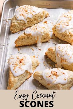 scones with white frosting and orange sprinkles on a baking sheet