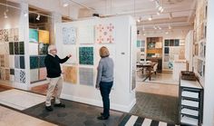 two people are looking at art on display