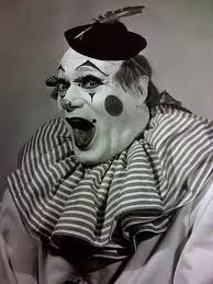 an old photo of a clown with his mouth open