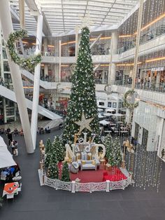 a christmas tree in the middle of a shopping mall