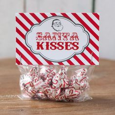 a bag of santa kisses sitting on top of a wooden table