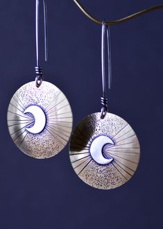 "Long dangle moon earrings. The \"Eclipse Rising\" earrings feature sterling silver crescent moons on hand stamped and carved brass OR sterling silver, choose option at checkout. Attached to long sterling silver earwires. The moon earrings have been given a patina to darken certain areas for character. Sanded and polished for a refined rustic appearance. These statement earrings are perfect for any moon jewelry collection and gift. These are available in all sterling silver or brass with sterlin Handmade Crescent Celestial Earrings, Half Moon Phase Brass Earrings, Bohemian Sterling Silver Sun And Moon Earrings, Bohemian Sun And Moon Sterling Silver Earrings, Silver Moon Phase Brass Earrings, Silver Moon Phase Earrings In Brass, Brass Half Moon Earrings, Silver Half Moon Brass Earrings, Silver Moon-shaped Brass Earrings