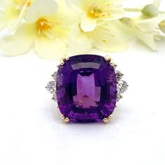 This large cushion cut amethyst ring would be perfect as a cocktail ring or statement ring. The Amethyst has beautiful color, and the diamonds are very high quality. The setting was handmade to fit the stones - this is a stunning, high quality ring.    Metal Content: Solid 18K Yellow Gold  Size 6 - can be sized  Gemstone: Cushion Cut Amethyst Size in mm: 17.40 x 15.37 x 10.88 Carat: 17.8 ct Diamonds: 10 Round Brilliant Cut Carats: .80ctw Clarity: VS2 Color: G Ring Face (North/South): 17mm Height of ring off of finger: 12mm Ring Shank Width: 2mm Weight:  8.5 Grams Stamps: 18k Condition: Excellent Estate Items will ship in a gift box or pouch Each piece is thoroughly examined and refinished as needed by our professional jewelers, tested to guarantee metal content,  graded by our in-house GIA Luxury Amethyst Cushion Cut Ring For Formal Occasions, Luxury Amethyst Cushion Cut Ring For Formal Events, Luxury Cushion Cut Amethyst Ring For Formal Occasions, Luxury Purple Cushion Cut Jewelry, Luxury Cushion Cut Amethyst Ring For Anniversary, Luxury Cushion Cut Amethyst Ring For Gift, Cushion Cut Purple Amethyst Ring, Fine Jewelry Cushion Cut Amethyst Ring, Fine Jewelry Amethyst Cushion Cut Ring