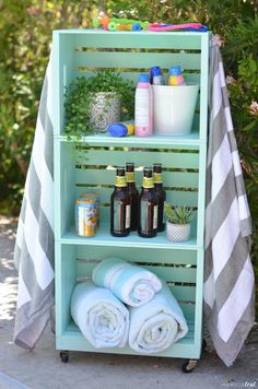 an outdoor shelf with towels and bottles on it