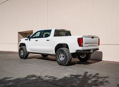 a white truck parked in front of a building