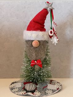 a christmas decoration made out of hay with a santa hat on it's head