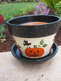 a potted plant with a pumpkin painted on it