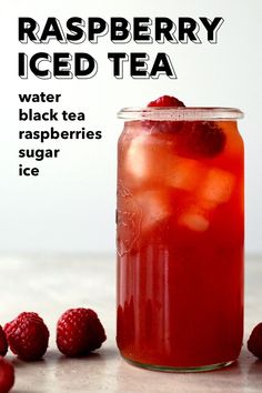 raspberry iced tea in a mason jar with ice and strawberries around it