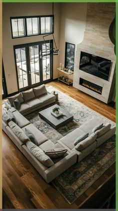 a living room with a large sectional couch and fireplace