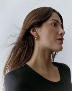 A pair of sleek, sculptural mini hoops, handmade by artisans in New York City from a 14-karat gold-plated recycled brass with a scooped-out interior for lightness. Modern Yellow Gold Small Hoop Wrap Earrings, Modern Gold-tone Brass Huggie Earrings, Tarnish Resistant Recycled Gold Huggie Earrings, Modern Recycled Gold Hoop Earrings For Everyday, Modern Hoop Earrings In Recycled Gold, Modern Gold Huggie Wrap Earrings, Modern Yellow Gold Hoop Earrings In Recycled Gold, Minimalist Small Hoop Yellow Gold Earrings, Minimalist Small Hoop Yellow Gold Wrap Earrings