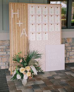 a couple of flowers sitting on top of a table next to a sign that says save the date