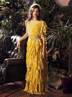 Editor's Note Featuring a yellow paisley print layered ruffle saree paired with an embroidered blouse and embellished belt design with handcrafted kasab work with mirror and swarovski embroider... Bhumika Sharma, Haldi Outfits, Saree With Belt, Haldi Outfit, Ruffle Saree, Yellow Saree, Dress Indian Style, Stylish Sarees, Saree Dress