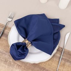 a place setting with blue napkins and silverware