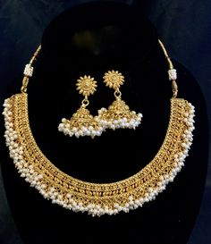 This is a Gold Finish Necklace with cream-colored pearls attached in clusters. They come with matching Jhumka with pearls attached. It sits on your lower neck on a collar bone. This necklace is very versatile. It goes very well with any traditional outfit, Kurti, or dress and will give your outfit an elegant look. Feel free to reach out to me with any additional questions Free shipping over $35 This necklace will be shipped in a beautiful gifting box from Los Altos, CA. Check out our other listi Heavy Pearl Bridal Necklace For Festive Season, Heavy Pearl Bridal Necklace For Festivals, Festive Bridal Necklace With Pearl Drop, Pearl Drop Jhumkas For Festivals, Festival Pearl Jhumkas With Pearl Drop, Festive Pearl Jhumkas With Pearl Drop, Pearl Jhumkas For Diwali, Chandbali Bridal Necklace With Pearl Drop For Festivals, Pearl Jhumkas For Wedding And Festivals