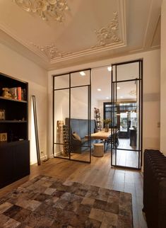 a living room filled with furniture and a large glass door that leads to an outside patio