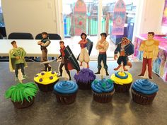 cupcakes with toy figures on top of them