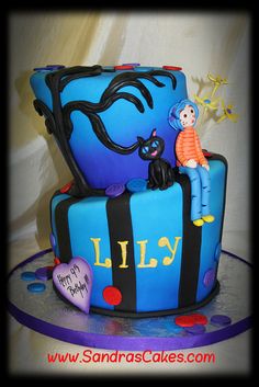 a birthday cake that is shaped like a suitcase with a cat on top and the name lily written on it