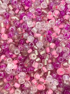 pink and silver beads are shown in close up