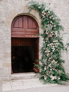 an instagram page with flowers and vines growing on the side of a stone building