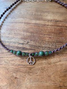 -Hemp macrame peace sign beaded choker necklace.  -Length- 14-16  inches -Agate is for strength and courage, & protects its wearer from danger and to promote healing.  -Each intricate knot and carefully chosen bead was crafted with positive energy and precision, making this piece a true work of art. Bohemian Agate Jewelry With Adjustable Cord, Hippie Beaded Choker Necklace, Hippie Beaded Choker Necklace As Gift, Hand-strung Hippie Jewelry For Meditation, Hippie Hand-strung Jewelry For Meditation, Adjustable Natural Stones Hippie Jewelry, Adjustable Waxed Cord Hippie Necklace, Adjustable Hippie Jewelry With Gemstone Beads, Spiritual Macrame Jewelry With Round Beads