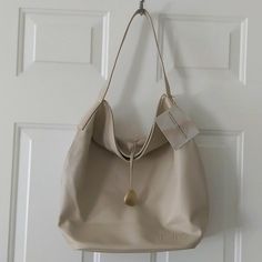 New, With Tags, True Color Is An Ivory/Beige Not Tan. Very Clean Inside And Outside. This Is Weekend Or Beach Tote/Shoulder Bag, It Has A Lot Of Room Inside It Has Snap Closure . Measurements: Photographed, See Pictures